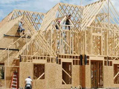 Construction workers building a house