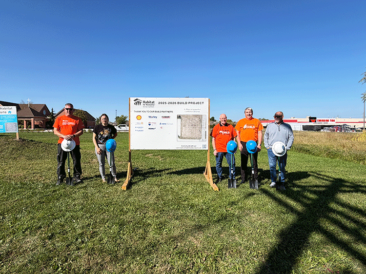 Staff and Mayor pose in front of build site